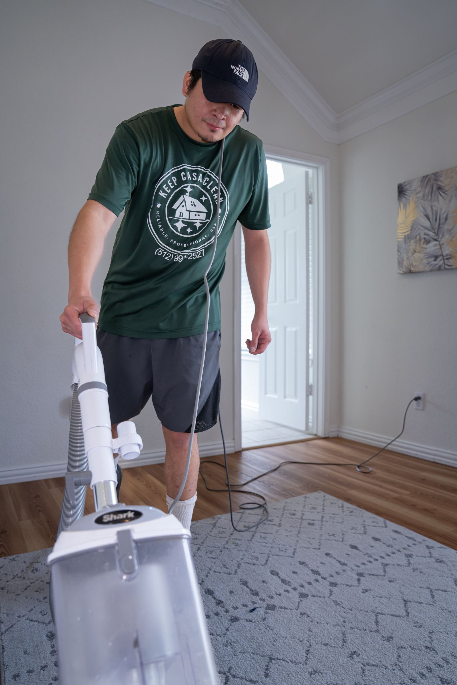 Keep Casa Clean team member cleaning a bathroom sink and mirror